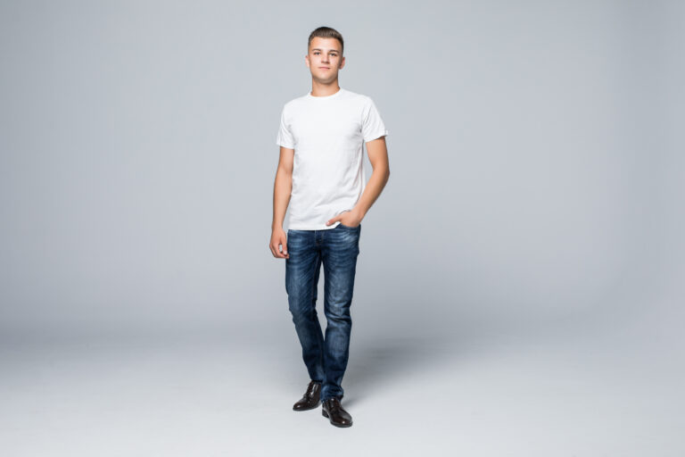 Handsome young man in a casual style clothing white t-shirt and blue jeans on white background Handsome young man in a casual style clothing white t-shirt and blue jeans on white background